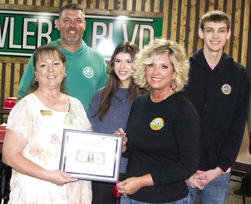 Operators of Bowlers Blvd in Columbus, Chris and Amy Johnson received their first dollar certificate from Chamber board member Sonja Duley during a ribbon cutting for the new member. Also pictured are Manager Allie Smith and Chris and Amy’s son Seth Johnson.