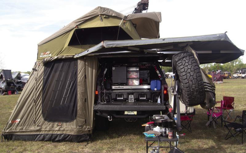 This pick-up truck is inside the tent and has all the needs. For a week-end camp out in the truck. The owner his entire camping equipment goes inside his garage during the week.