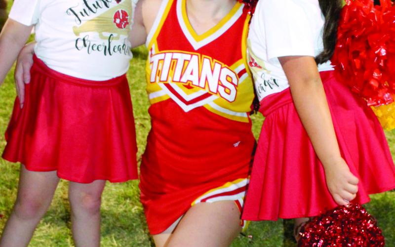 Heavin Miller joined Columbus High School Cheerleader Chesney Dobkins and Evolyn Luna during the haftime show at a recent football game.