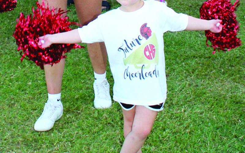 Getting ready for a career in cheerleading, Blake Evans shows her moves with the Columbus High School Spirit Squad a recent Titan home football game. Youngsters of all ages joined CUHS on the field for the halftime show.