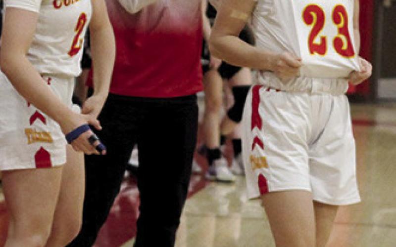 Lady Titan Seniors, Graci Major and Katie Simpson, and Lady Titan Head Coach, Matt Leet, celebrate a win at home during the MOKAN Classic Tournament early in the 2023-24 season. Columbus will be back on the court January 5 at Girard for boys and girls games beginning at 4:30 p.m. with junior varsity action.