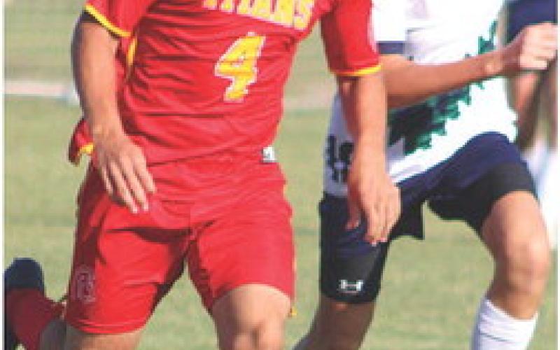 Titan Dallas Scott drives the ball toward the Liberty Home School Goal during a recent match on the Central School home pitch. The Titans are still looking for their first win.