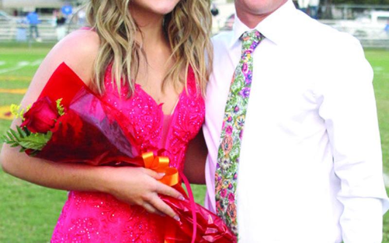 Lady Titan Senior, Ava Harman, was chosen as 2023 Fall Homecoming Attendant, Friday night, prior to the football game with St. Mary’s-Colgan. Ava is the daughter of Heath and Ashley Harman. She was escorted by Dallas Scott, son of Tim Scott and Cindy Hughes.