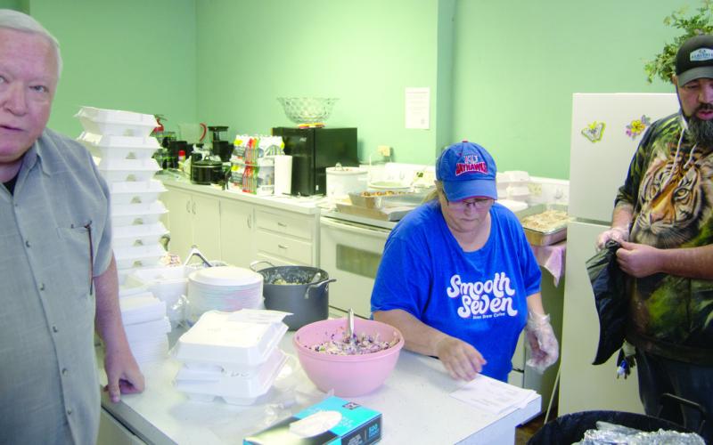 Pastor Alan McCamey and Cheri McCamey and Jesse Smith were among those serving up lunches at the fundraiser for the Christmas family recently.