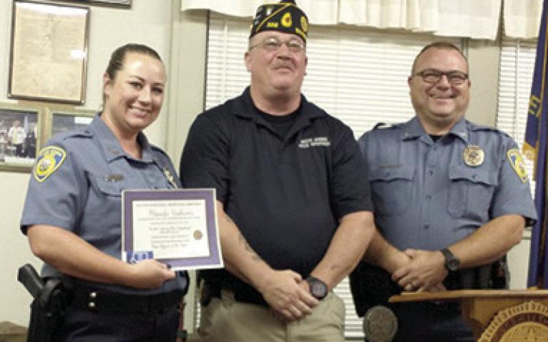 Rhanda Andrews was presented with the Baxter Springs American Legion Post 206 Officer of the year award. Legion Commander Darryl Nadeau presented the award at a recent meeting. She was nominated by Baxter Springs Police Chief Brian Henderson. Courtesy photo.