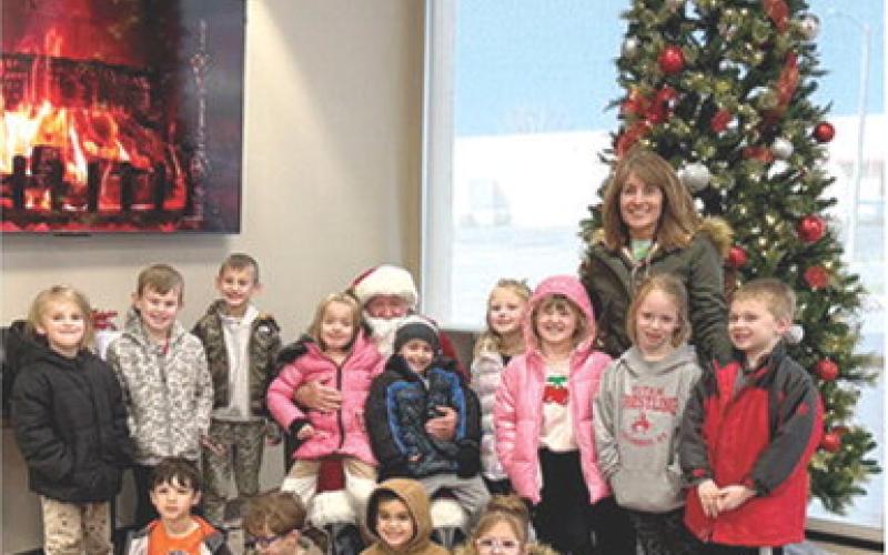 A special trip was in store for Suzette Henderson’s Park Elementary Kindergarten class. Santa Claus made a special early stop in Columbus to visit with youngsters. Class members were able to tell Santa what they wanted for Christmas and of course, get their photos taken with him to commemorate the day. Courtesy photo.