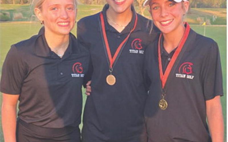 Lady Titan Eighth Grader, Tyler Kirk, (right) won the girls division of the 2026 junior high golf opener with a round of 49 at the Independence Country Club, Monday. Kip Saporito (center), CJHS Eighth Grader, placed seventh with a 65 to help lead the co-ed team to a fourth place overall finish. Fellow eighth grader, Raylee Engroff, rounds out the Lady Titan members of the team. Columbus will be back in action Monday in Pittsburg starting at 2:30 p.m. at the Four Oaks Golf Course. Courtesy photo.