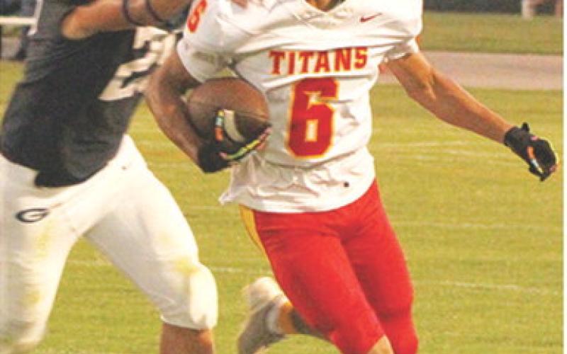 Titan Freshman, Jaydan Dohle, breaks away from Senior, Evan Wittenmyer as he takes off on his 80-yard catch and run touchdown from sophomore, Cole Howard in Friday’s 13-20 loss in Galena.