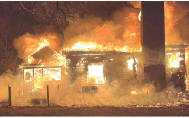A two story house on Parmenter was a total loss after a fire March 18, despite the efforts of multiple fire departments. Strong winds put surrounding residences in danger, but they were saved due to the actions of the firefighters. Courtesy photo.