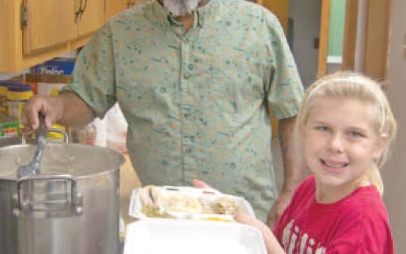 The last thing on the plate is Bill Jones’ “famous” gravy dipped hot from the kettle. Volunteer Rylie Oehme was carrying the to go orders to each of the servers before passing the dish to the delivery volunteers.