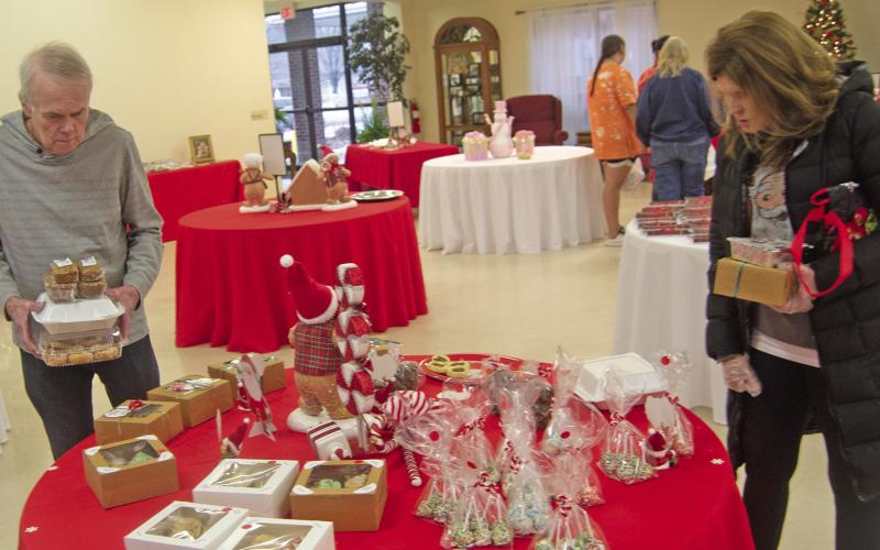 Loaded down with cookies and other goodies at the St. Bridget’s Cookie and Bake Sale Randy Pierce and Sally Albright were looking at the options. The cookies go quickly after the sale opens.