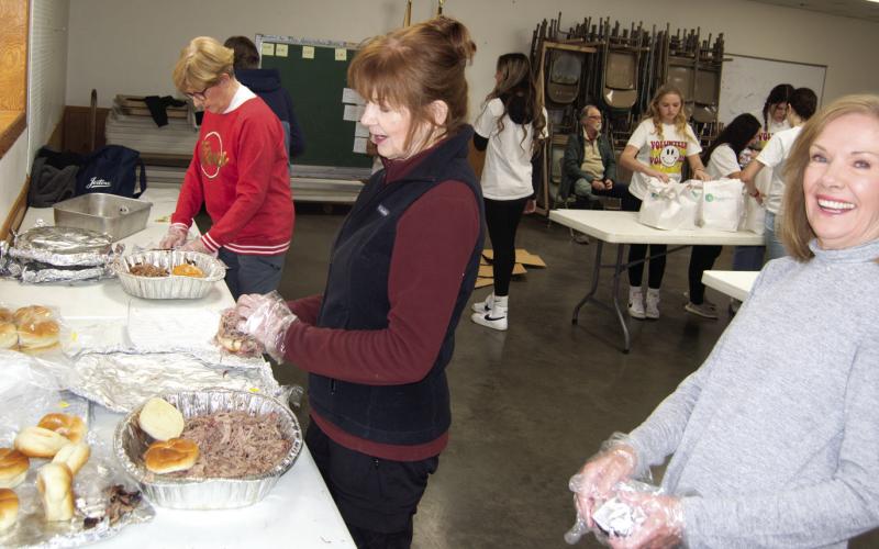Pat Daughtery, Donna Murdock and Mary Jane Simpson helped to assemble the pulled pork sandwiches at the fundraiser held February 1 at the 4-H Building. The proceeds were distributed between Tracy Lopp, Fern Henderson and Larita Hendricks.