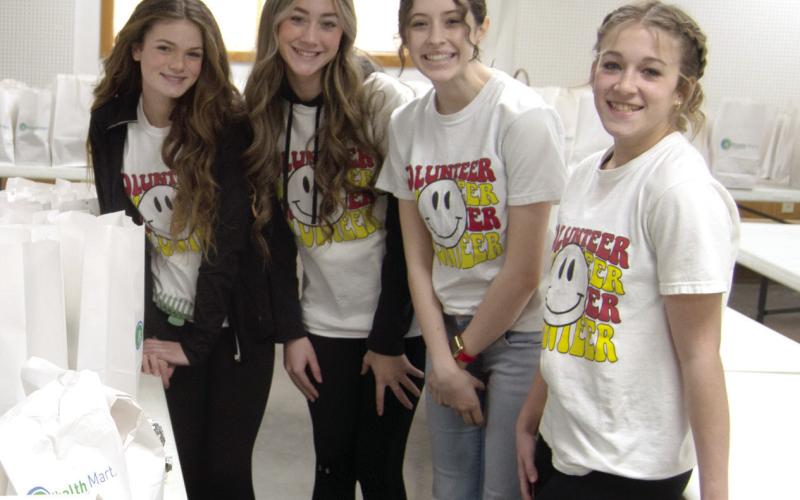 A group of eighth graders volunteered to help out at the recent fundraiser for Tracy Lopp, Fern Henderson and Larita Hendricks. Laney Atkinson, Faith Williams, Natalie Wary and Tatum Kirk assisted with packing and distributing orders at the event.