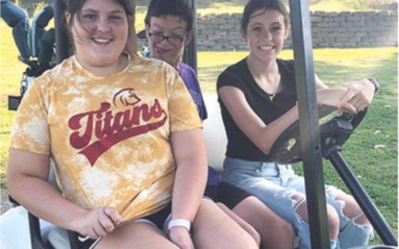 Lady Titan Freshman Golfers Jaiden Campbell and Natalie Wary with their golfing buddy head out to their tee off hole during the Special Olympics Golf Tournament held at the Pittsburg Golf Course last week. Courtesy Photo.
