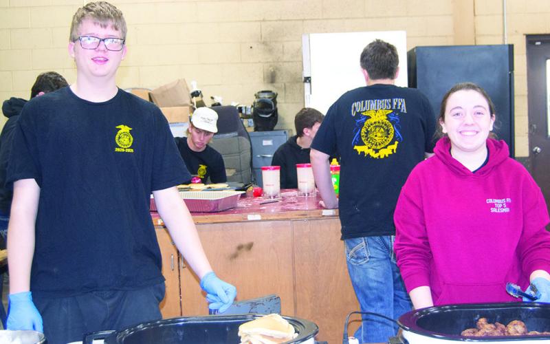 Columbus High School FFA members Alex Thomas and Ava Allison serve pancakes and sausage to the community February 26. FFA members gathered to serve the community breakfast as part of their national FFA week activates. News Report photo by Tanya Woolsey.