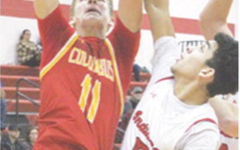 Titan Sophomore, Jonas Stover, scored 27 points in the Columbus season opener at Oswego. Demitri Wiliamson, Indian Sophomore, defends. Williamson led Oswego with 16 points.