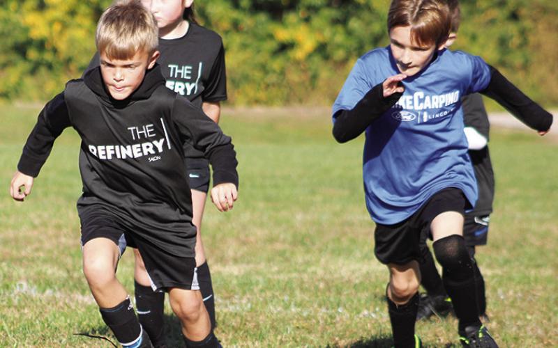 Roman Atkinson, Ruby Ellis and Phoenix Rider battle down the field during the Columbus Area Youth Soccer season in September and October at Eddington Park. The season wrapped with team parties at the pumpkin patch.
