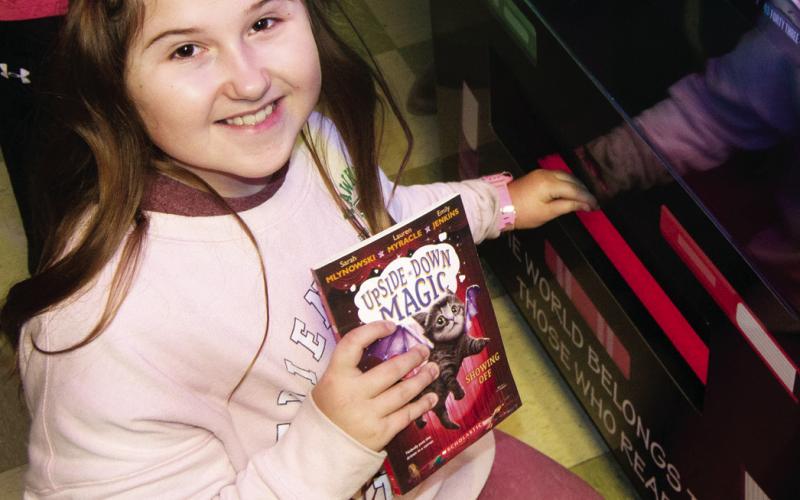 A ribbon cutting ceremony was held Wednesday for the new book vending machine installed at Central Elementary in Columbus. Addlyn VanGilder showed off her newly chosen book.