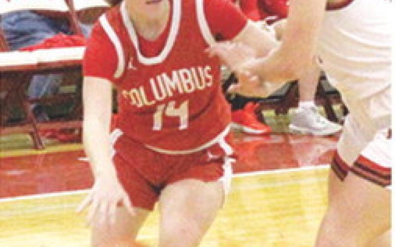 Lady Titan Junior, Bentley Townsend, drives to the basket past Oswego Freshman, Colby Pease in the, 31-28, Columbus season opening win at Oswego. Bentley scored eight points in the win.