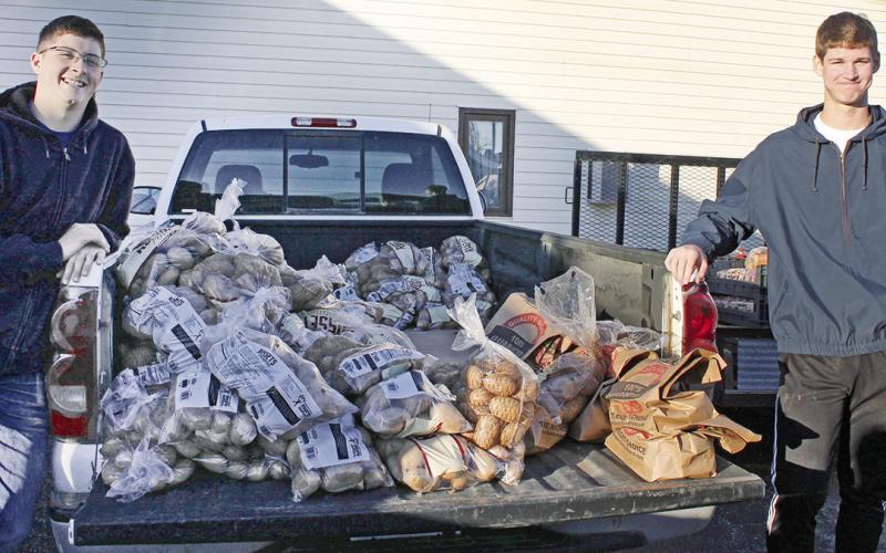 Volunteers distribute Thanksgiving boxes to community