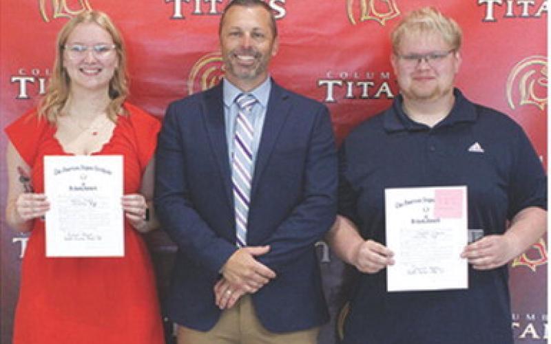 Chloe Rogers and Maddox Ochsner received the American Legion Award and Scholarship in the amount of $250 each from USD 493 Administrator, David Dainty during the 2025 Senior Assembly, May 16, at the Columbus Unified High School Gymnasium.
