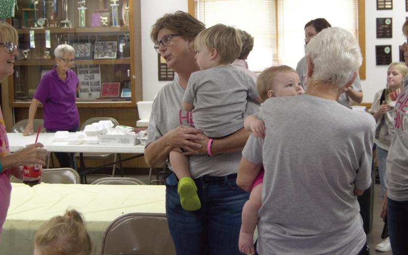 Friends and family of Traci Spear (holding grandson James Hodgson) attended the pulled pork fundraiser held at the 4-H Building September 28. Proceeds will go for treatment and travel expenses.
