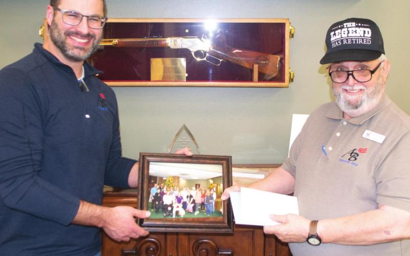 Saying farewell to a long-term employee, American Bank President Taylor Hight presented retiring teller, Dennis Webb a photo of the bank’s staff, plaques and other gifts. Webb worked in the Baxter Springs office of the bank for 20 years. The public is invited to a special retirement reception for Webb January 14 from noon-3 p.m.