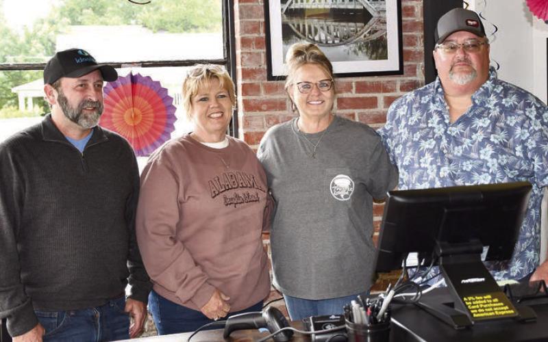 At the recent ribbon cutting at Twister Liquor in Baxter Springs, Chamber members John Terry and Michele Rickman joined Twister Liquor owners, Kim Perry and Dave Lewis inside the newly opened store. Photo by Tanya Woolsey.