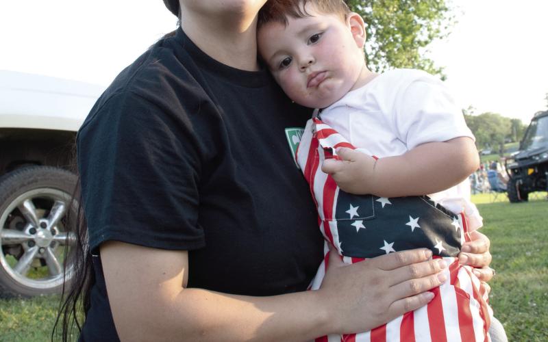 Light up the Sky event held at Kiwanis Park in Baxter Springs was a sea of red, white a blue as residents and visitors gathered to celebrate the nation’s Semiquincentennial. Cohen Moates, in the arms of his mother Josefina Moates, shows off his festive digs.