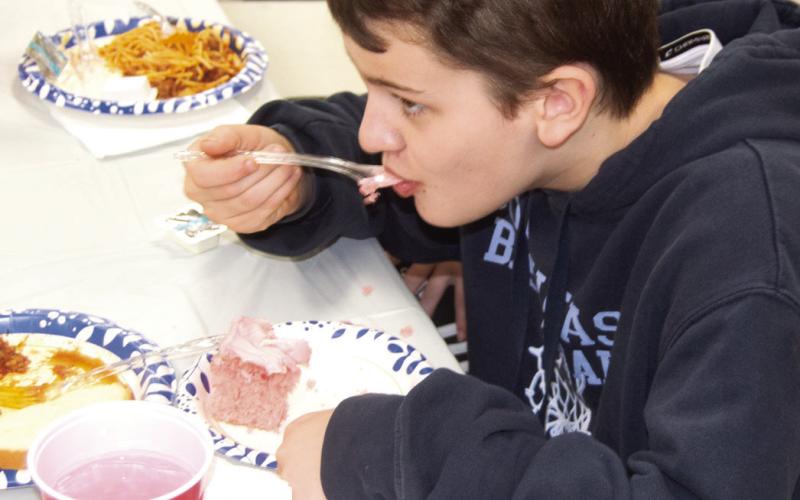 A very successful spaghetti fundraiser for Jon Tavernaro in the Weir Community Center on Saturday. Blake Sanders enjoyed a bit of cake to finish off the meal.