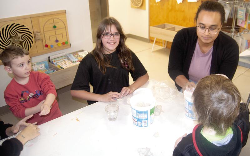 Librarian Lauren Dainty of the Columbus Public Library often plans creative events for children. Recently youngsters created “pinch pots.” Jeremy Davidson and Kaylyn Anderson were two of the youth participating in the event.