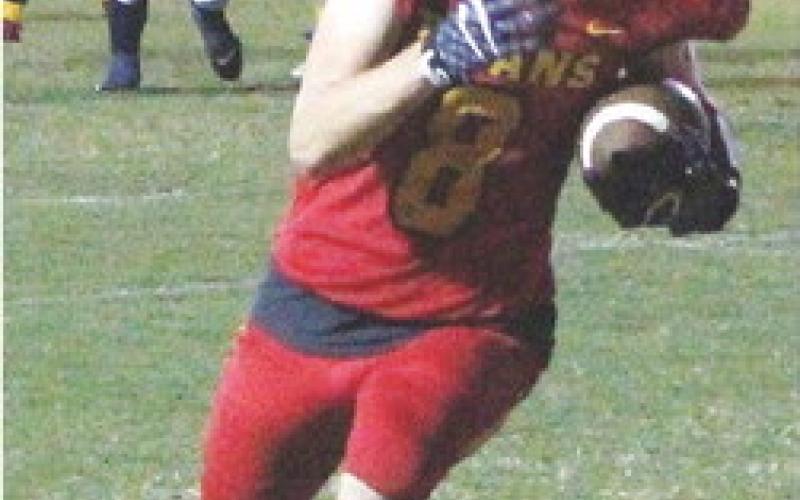 Titan Junior, Jace Midgett, makes the catch at the five yard line and scrambles into the end zone for the first Titans points of the game in the, 12-8, Columbus win over Galena, Friday.