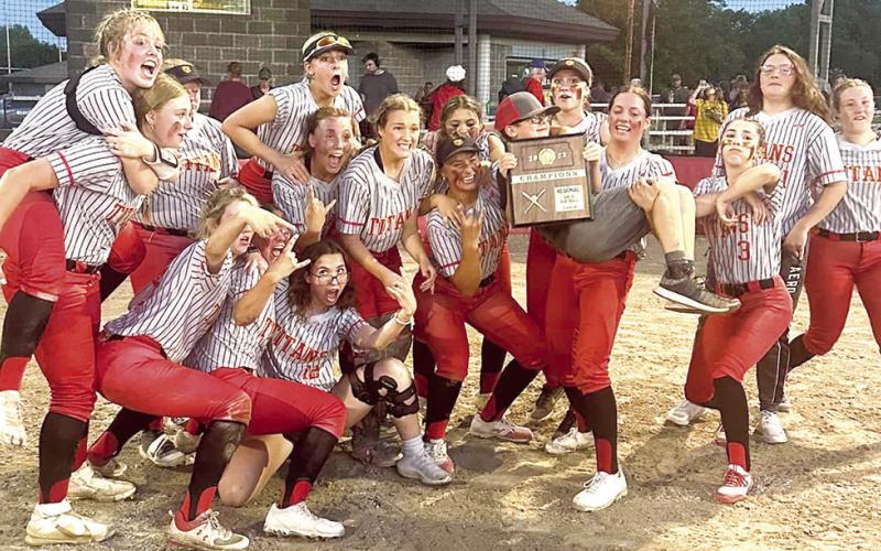 The Columbus Lady Titans celebrate after receiving their Kansas Class 3A Regional Championship plaque, Wednesday, at Rockette Field in the Columbus Community Field Ballpark. The Lady Titans are seeded third in the Kansas Class 3A State Tournament in Manhattan and will play the 7 p.m. quarterfinal game, Thursday, against Rossville (17-4), the sixth seed. The tournament is being hosted at the Twin Oaks Complex.