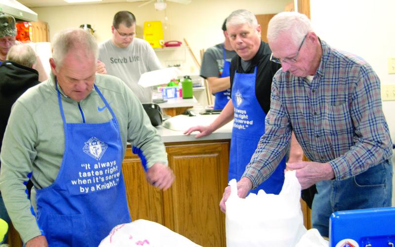 Steve Kresyman, Jay Wary and Joe Niggeman were among those helping out at the Knights of Columbus chicken noodle lunch and dinner March 12. News Report photos by Tanya Woolsey.