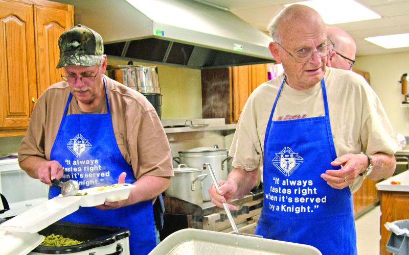 Brad Gleason Ralph White were dipping green beans and noodles at the Chick Knights of Columbus chicken noodle lunch and dinner held at St. Rose Parish Hall March 12.