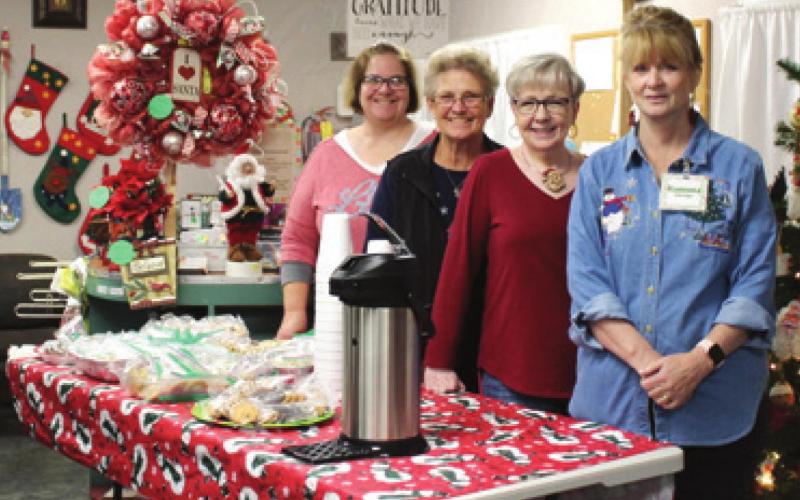 Lori Baker, Ann Mccorkle, Sharon Tucker, and Ramona Eldridge prepare to serve the community of Baxter Springs with their first ever Open House at the Grace and Gratitude Thrift Store. The ladies served cookies and hot cider, and gave away door prizes. The two hour open house brought in over $300 that will be used to buy food items to be distributed over Christmas Break from the Grace and Gratitude Food Pantry. Photo by Dee Riley.