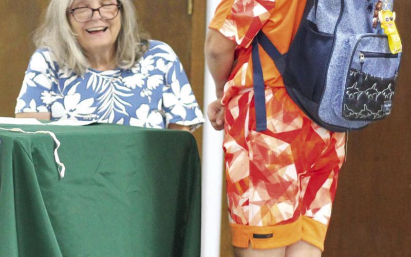 Luke Bell discusses his outfit with one of the judges during the annual 4-H Style Revue Saturday, June 27 at the Extension Office.