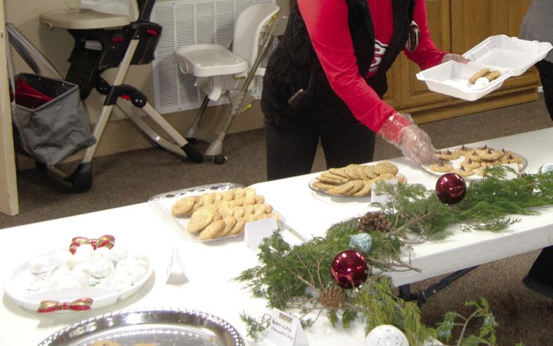 Columbus First Christian Church held their 34th annual Cookie Walk earlier this month. Above, Mary Epler, Jamie Mason, Cheri Walden and Retha Schultz organized the French Press cookies for the event. At right, Kari Soper makes her selection from the many varieties off cookies offered. The event is so popular that cookies sell out early each year. With so many options to choose from, everyone is sure to find a cookie they really enjoy.