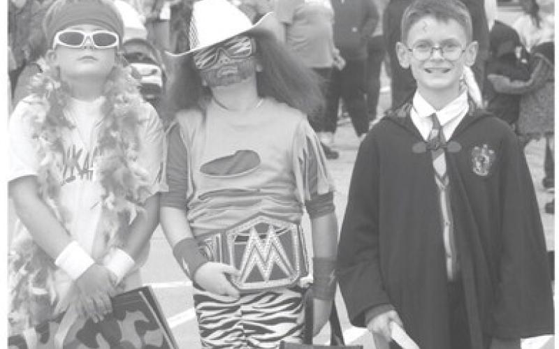 Costumes of all sorts were seen on the Columbus Square Friday, October 31. The annual Halloween Walk was attended by Trapper Clark, Kasey Rowe and Connor Crain. Photo by Shawn Churchill.