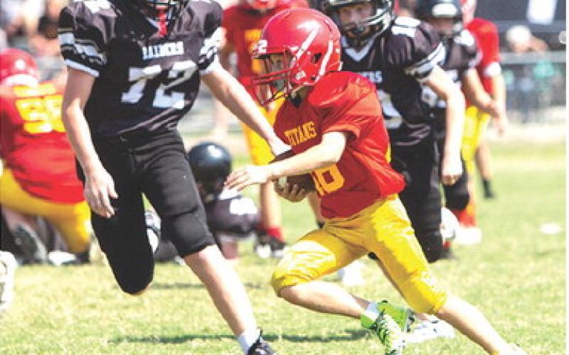 The Columbus Fifth and Sixth Grade Titan Team hosted Frontenac, September 16, at Titan Stadium. Tanner Scott ran up against some big guys on defense during a good run. The visitors clipped the locals, 26-20 in double overtime, handing Columbus their first loss of the season. Photo courtesy Kristin Sharp.