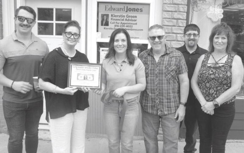 Rebecca Spooner (second from left) presented Kierstin Green with her first dollar plaque during the ribbon cutting ceremony and open house. Green was joined by members of her family on the occasion, Mike Newaczyk Chris Green, Bryson Green and Connie Lett.