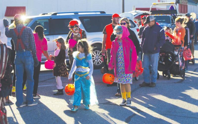 Part of the crowd for the Halloween Trunk or Treat event along Pine St. in Columbus, line up for candy at each of the vehicles parked along the street. Colorful costumes intermingled with the festive and creative displays for a day of family fun thanks to the Columbus Chamber of Commerce’s organization and resources. Photo by Jacob Spencer