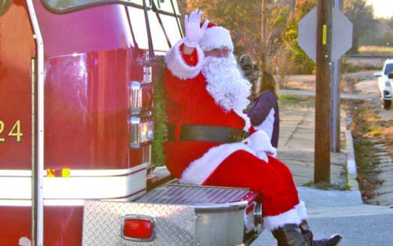 Santa made is first stop in Cherokee County during the Scammon Christmas parade Sunday, December 1. He was escorted to by members of the Scammon Fire Department.