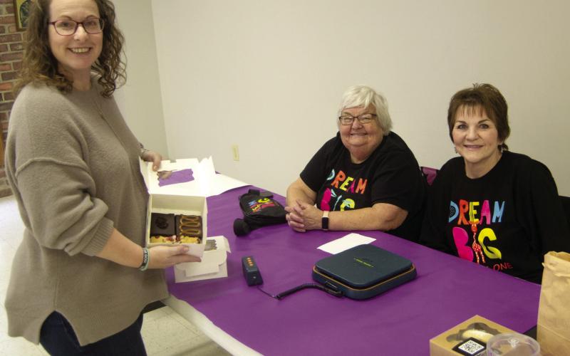 Kirsten McNeal was paying for her cookie purchase at the Dream Big Little Ones benefit Mavis Bowen and Luann Nicoletti were weighing and collecting the funds.