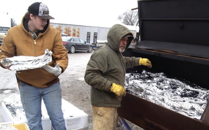 Saturday morning before Super Bowl Sunday was a busy time for the Columbus Titan Football players as they prepared 300 sides of spare ribs for distribution throughout the area.