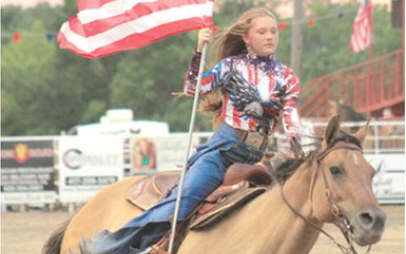Akissa French carried the American Flag into the arena during the Baxter Springs Saddle Club rodeo held recently. Courtesy photo.