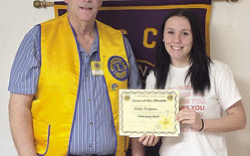 Brad Gleason presented February Lion of the Month Katie Simpson with her certificate at a recent meeting. Courtesy photo.