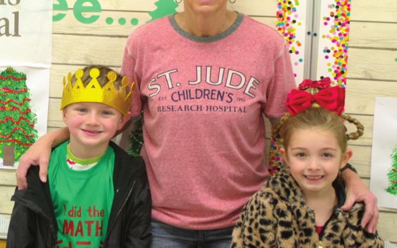 First Grade Bike-A-Thon King Lee Snow and Queen Elle Jessee pose for a picture with Bike-A-Thon and Trike-A-Thon coordinator Cindy Wells after the children’s awards cere-mony. Wells wears a St. Jude Children’s Research Hospital shirt, which is where funds raised by the children were sent. Photo by Jacob Spencer.