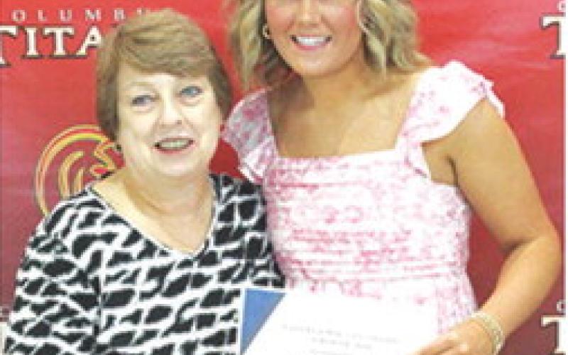 Kenadie Carter received the LaFerla Ortho Scholarship in the amount of $1,000 from USD 493 Instructor, Karen Langerot, during the 2025 Senior Assembly at the Columbus Unified High School Gymnasium, May 16.