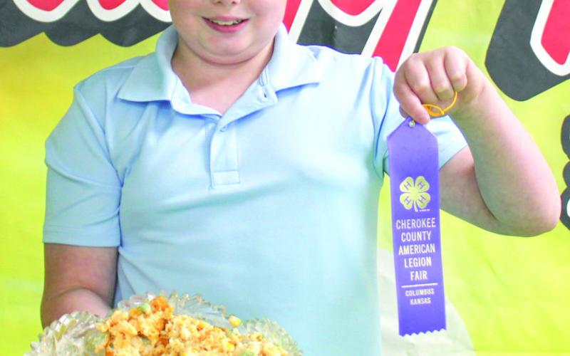 Kylen Killebrew, Glittering Stones, shows his purple ribbon and his entry in the Cherokee County foods show.
